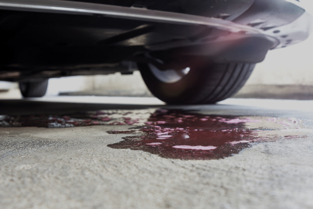 Fluid Leak Repair in Blowing Rock, NC, At L&N Performance Auto Repair. Close-up view of vehicle fluid leak on garage floor under a car