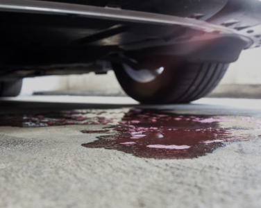 Fluid Leak Repair in Blowing Rock, NC, At L&N Performance Auto Repair. Close-up view of vehicle fluid leak on garage floor under a car